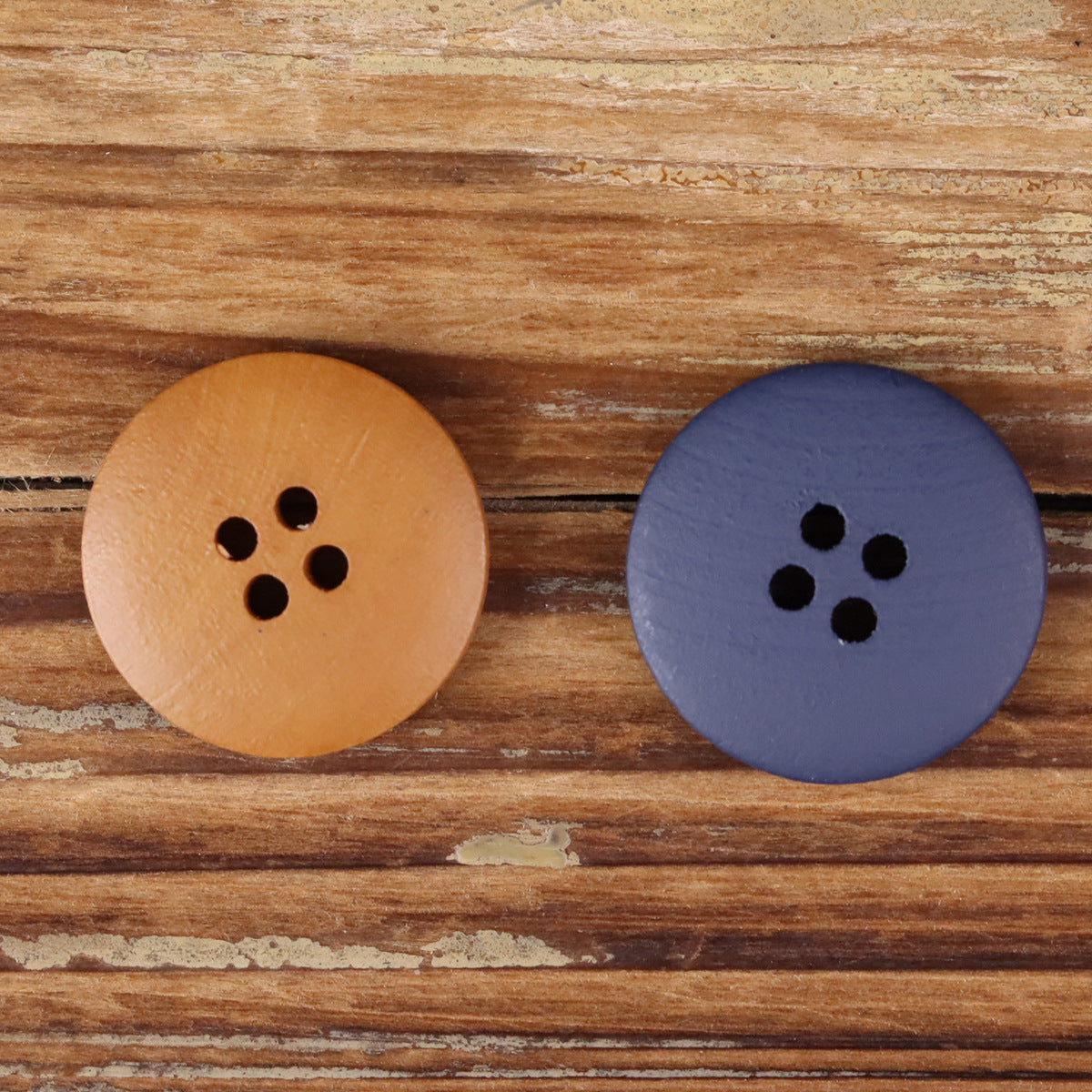 Brown and blue-purple round wood buttons with four holes