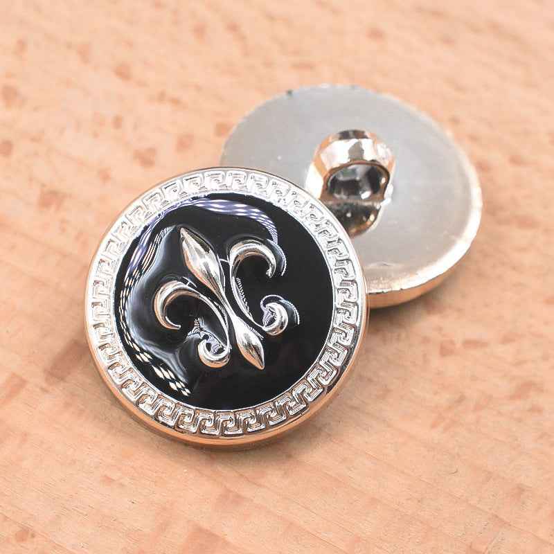 Black 21/23mm plastic shank button with floral-style decorative front and silver rim