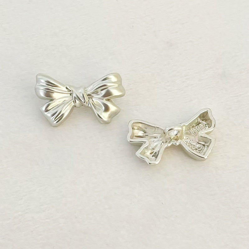 Matte silver bowknot metal shank buttons, hand-sew; front views of two bows