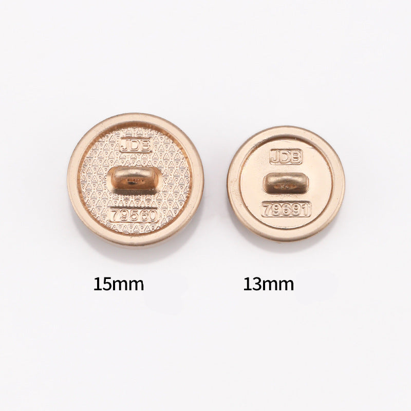 Back of cat-eye metal shank buttons with JDB marking and numbers, light gold tone