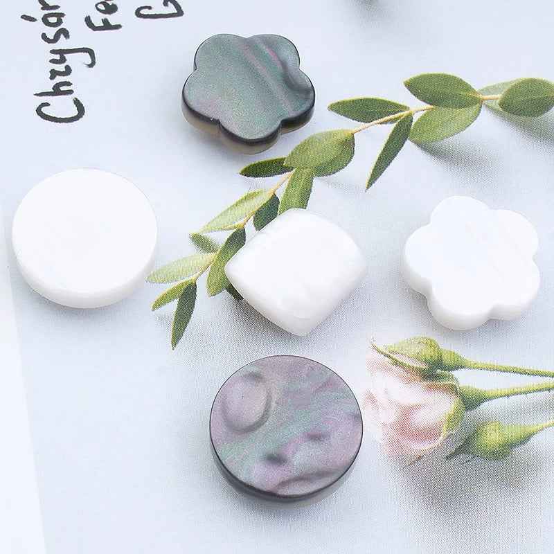 Pack of magnetic shirt collar clips with clover flower shapes in dark gray and white