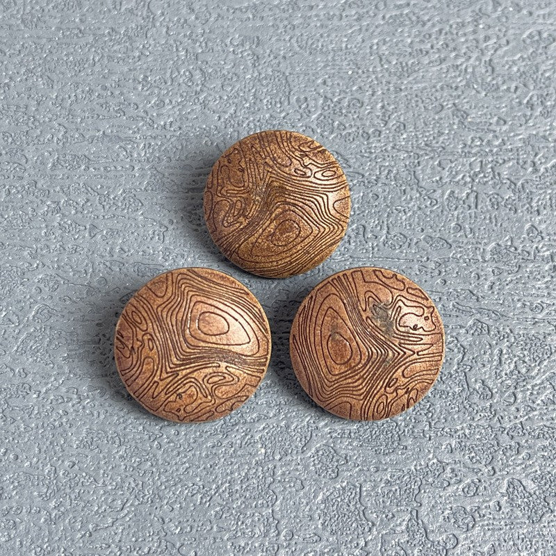 Three round wood shank buttons with carved mushroom-grain texture in light coffee