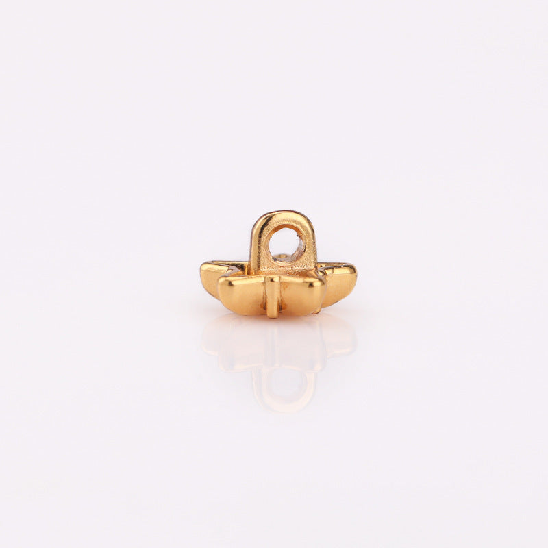 Gold-tone star metal shank button, back view with loop and prongs