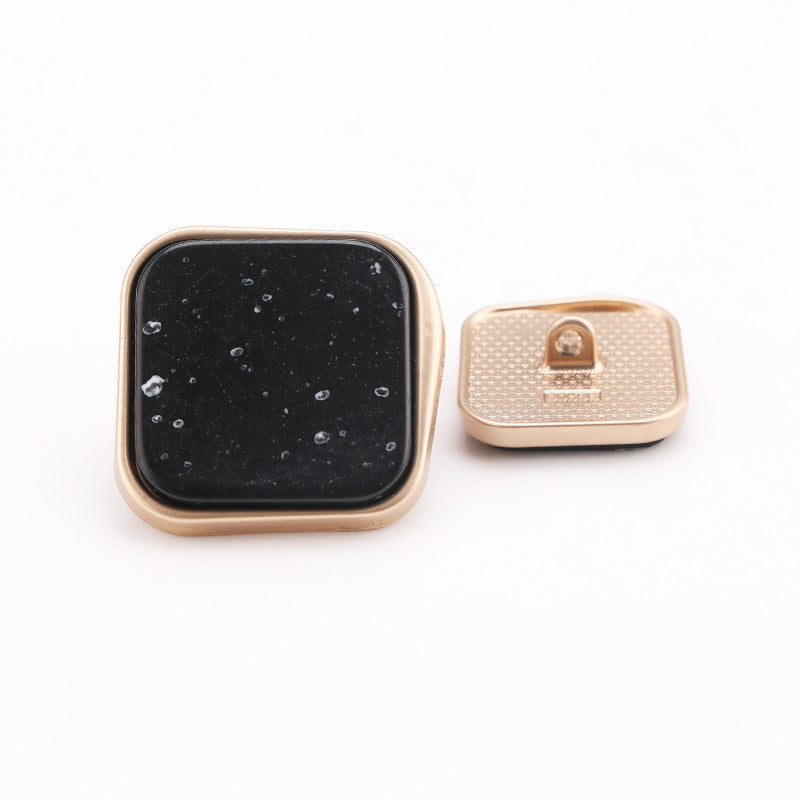 Cream marble square shank button with black dot design, gold metal frame