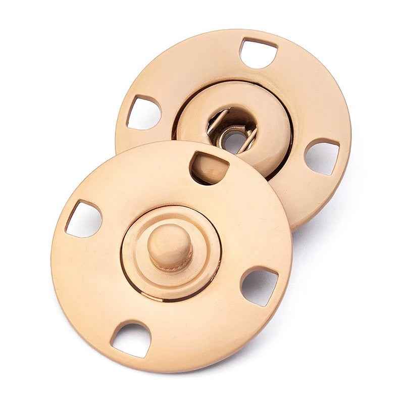 Matte gold hidden snap button pair, round discs with center dome and 4 attachment notches