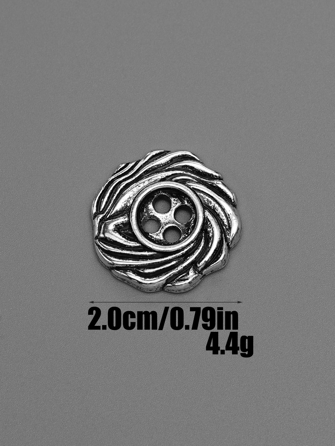 Silver 4-hole spiral metal button with circular swirl surround, front view