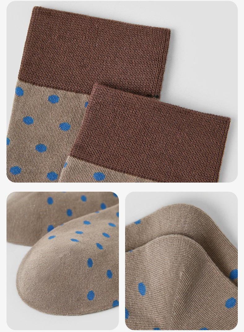 Beige crew socks with blue polka dots and brown cuff; close-up knit texture
