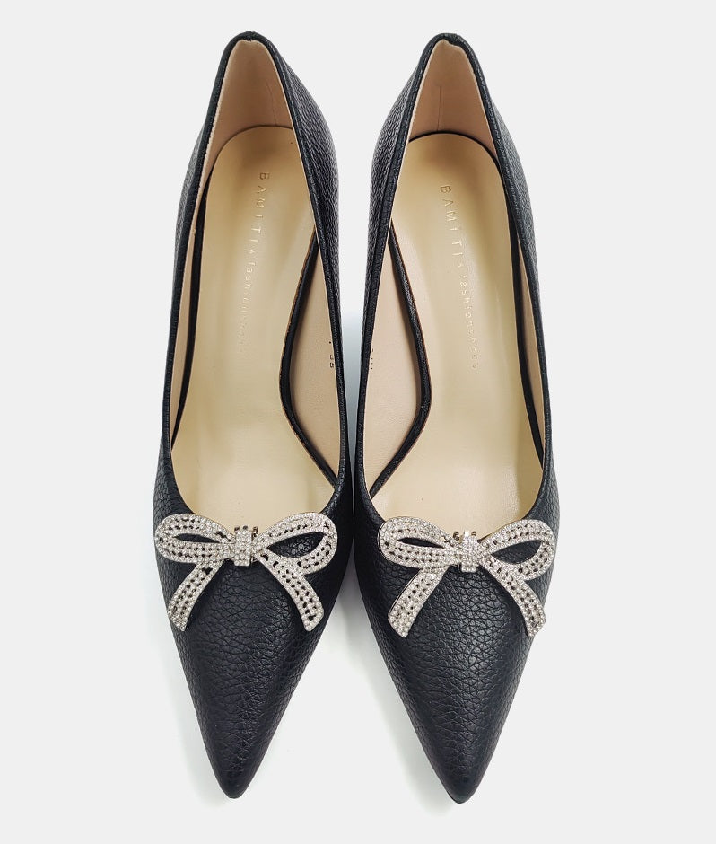 Silver rhinestone bow detail on black pointed-toe high heels, bow centered on vamp