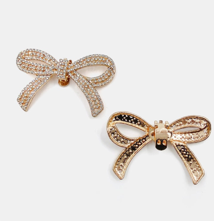 Gold-tone rhinestone bow clips, including one darker-stone accented bow style