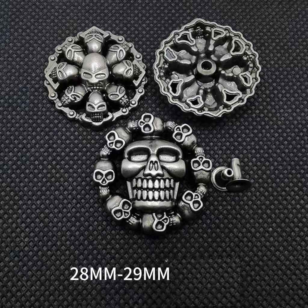 Skull rivet studs, silver-tone with skull faces and spikes; size 28–29 mm