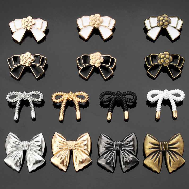 18 bow tie metal button assortment in white, black, gold, and silver tones