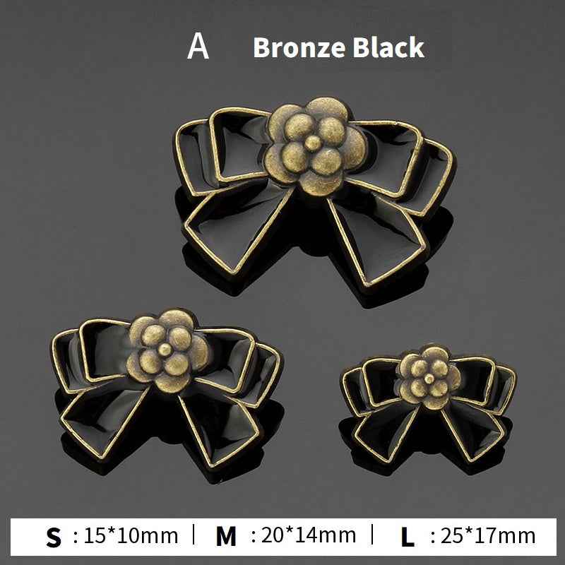 Style A bow buttons: bronze and black enamel flower center, 3 sizes shown