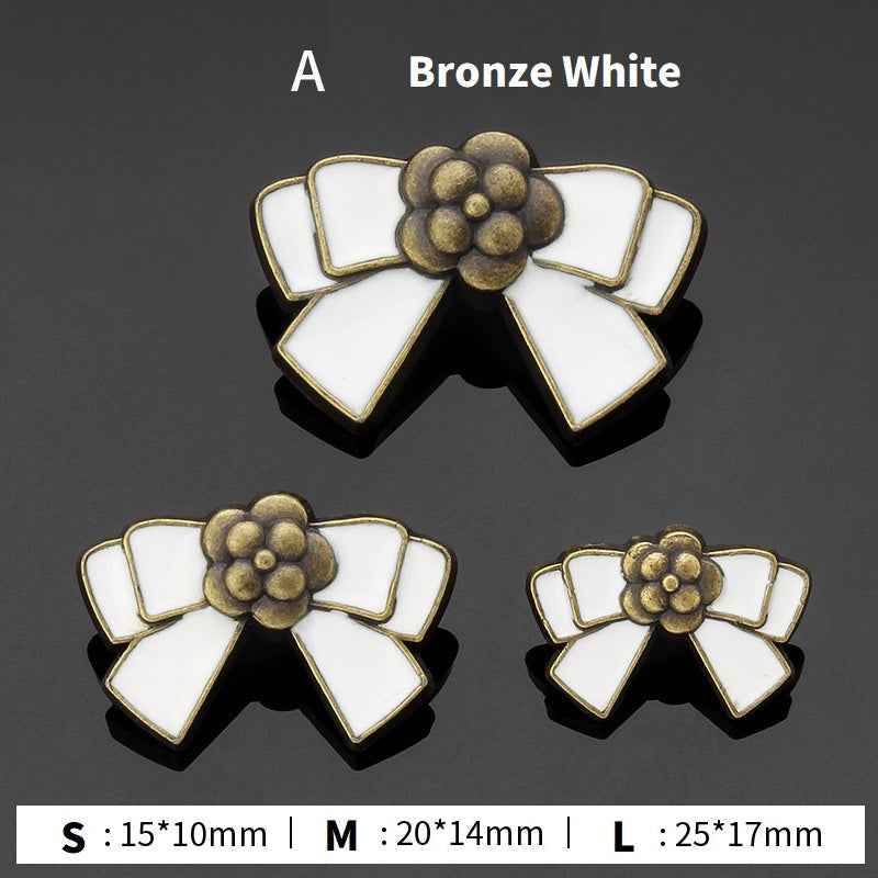 Style A bow buttons: bronze and white enamel flower center, 3 sizes shown