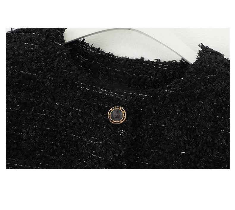 Small dark resin shank button on black fabric surface