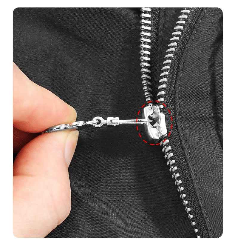 Hands pull a detachable metal zipper pull with flower charm on a black zipper