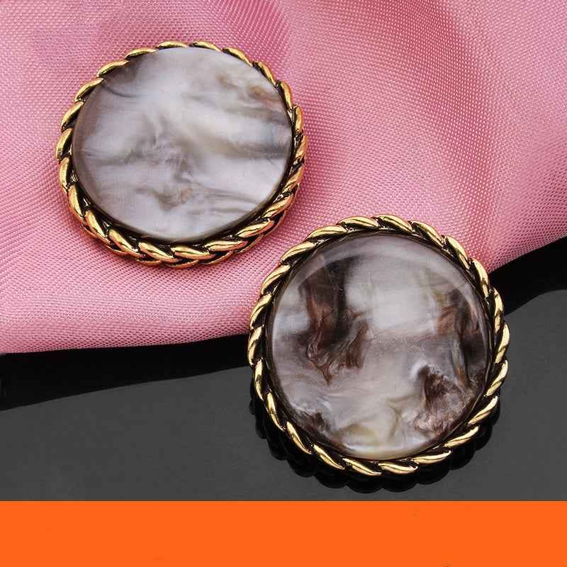 Two gray round resin buttons with gold braided edge, glossy marbled resin centers