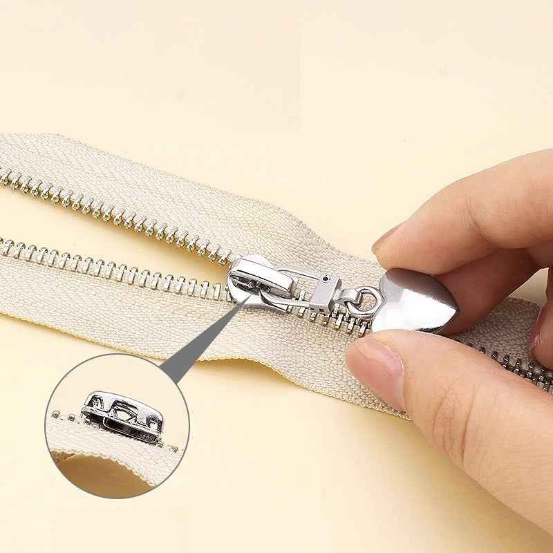 Heart zipper pull being clipped onto a zipper coil with metal latch