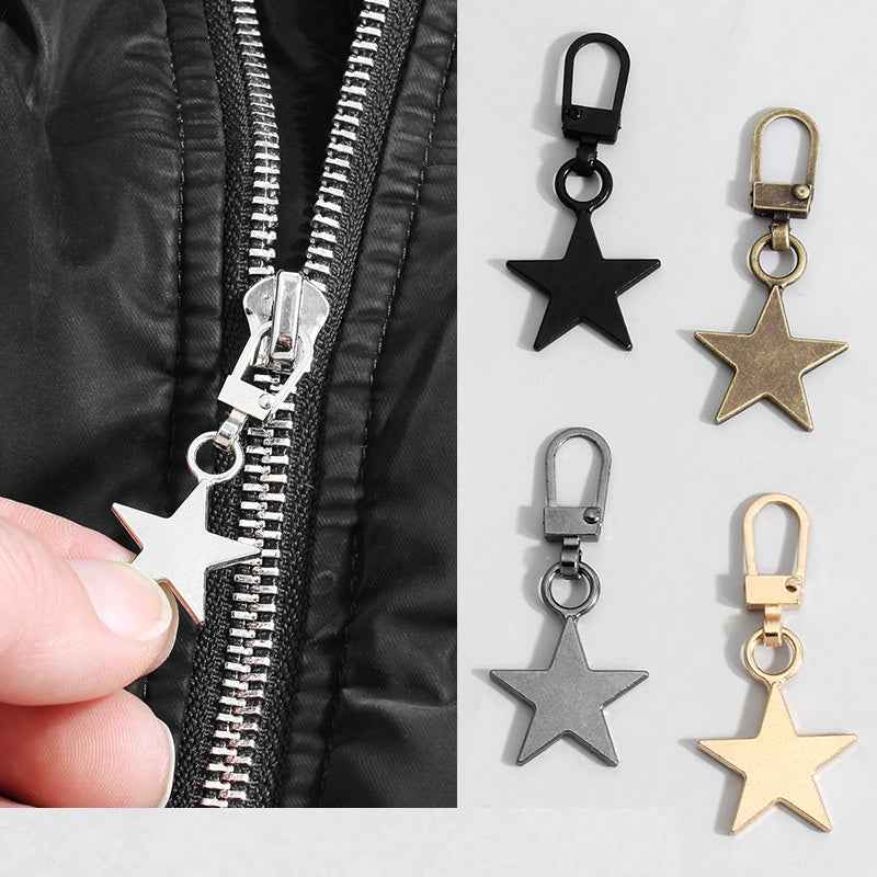 Zipper pull with detachable star charm, metal slider, black clip, dark garment with zipper