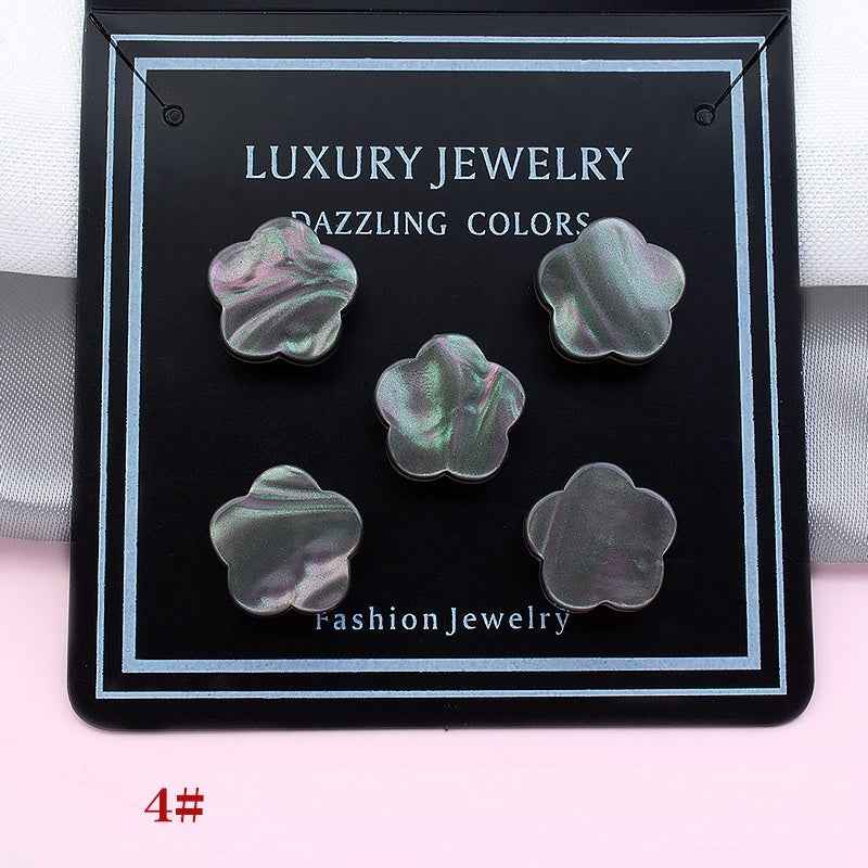 Mixed gray and iridescent clover magnetic collar clips on a display card, five pieces