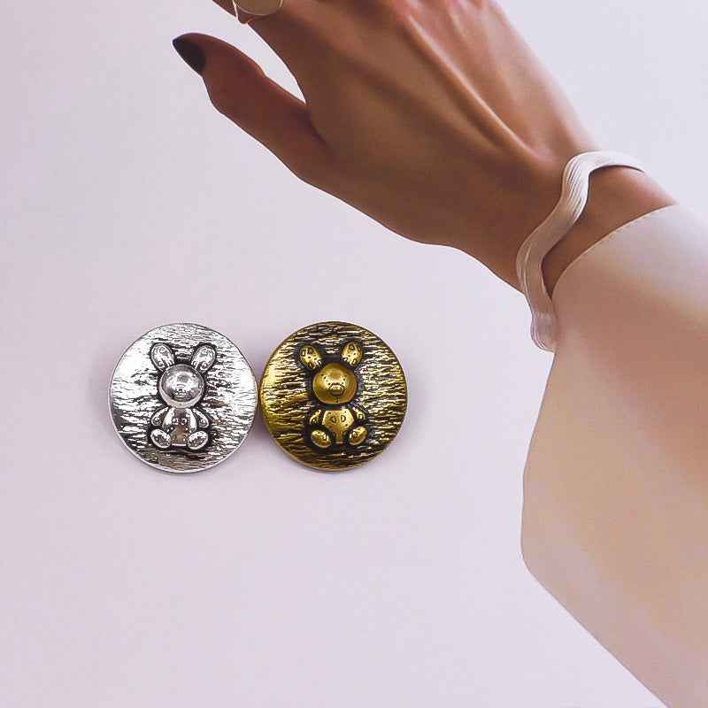 Pair of rabbit embossed metal shank buttons: silver and gold round