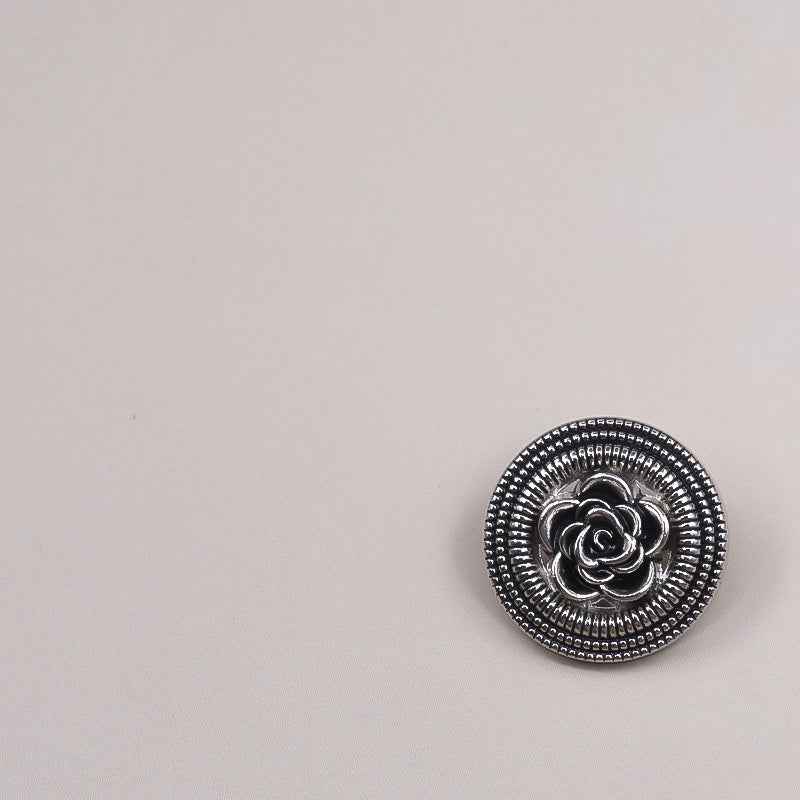 Vintage gold hollow rose metal button on black, beaded border and curled petal design