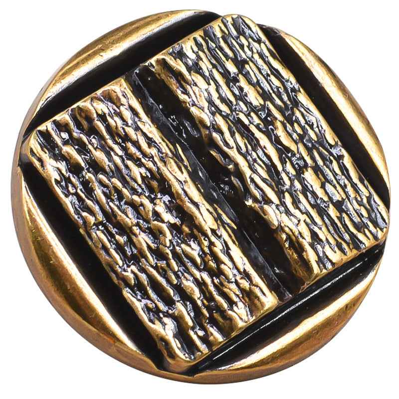 Gold metal shank button, concave textured pattern close-up