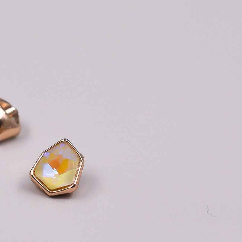 Irregular rhinestone button with pale yellow, faceted stone in gold-tone setting