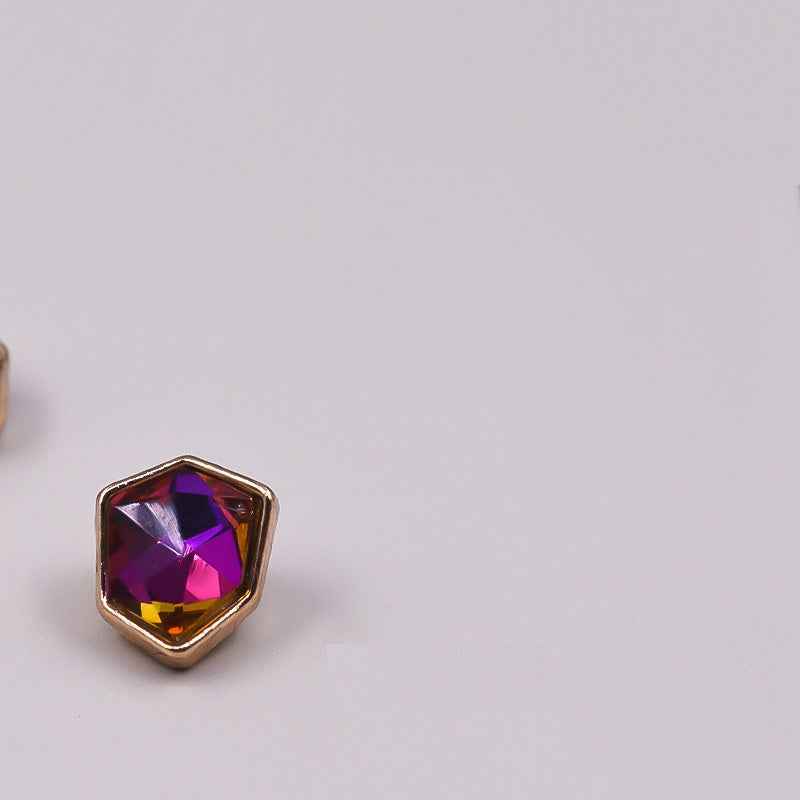 Irregular rhinestone button with dark purple faceted stone in gold-tone metal frame