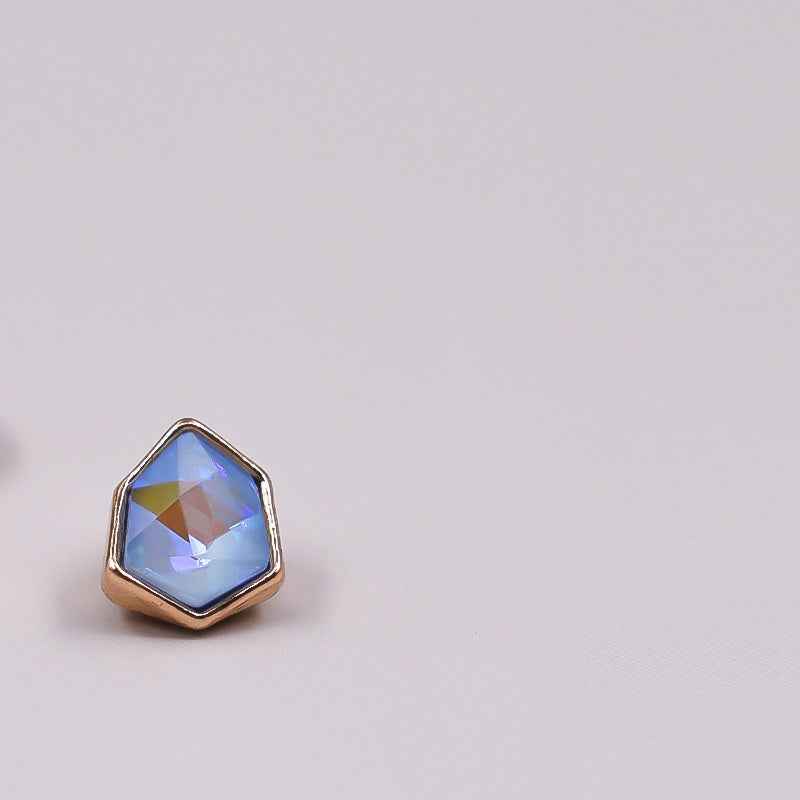 Irregular rhinestone button with light blue faceted stone in gold-tone setting