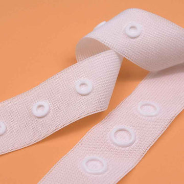 White sewing snap fastener tape strip with round snap buttons, spaced closures