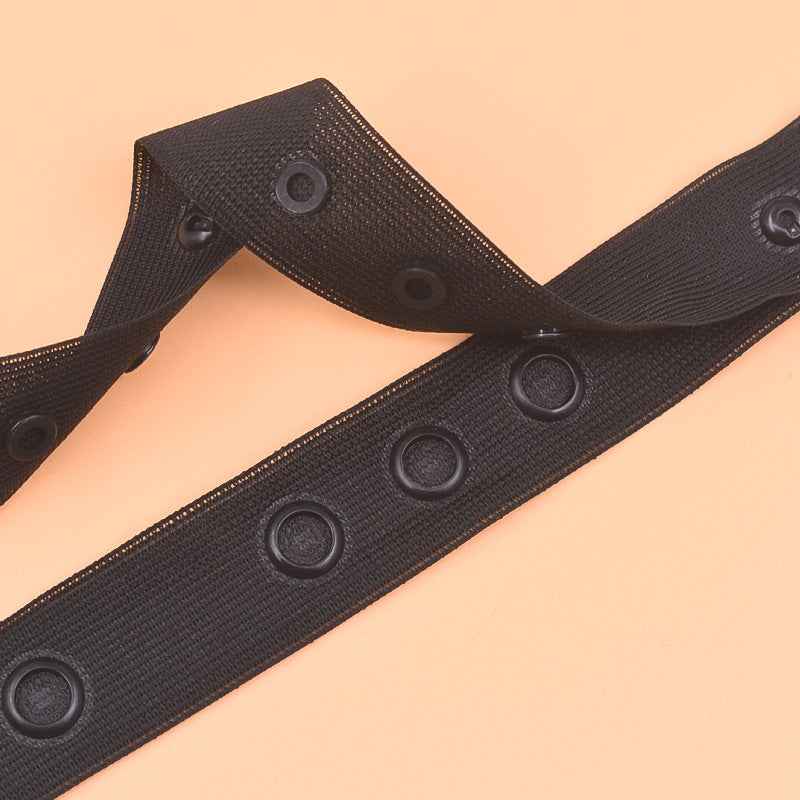 White sewing snap fastener tape strip with round snap buttons, spaced closures