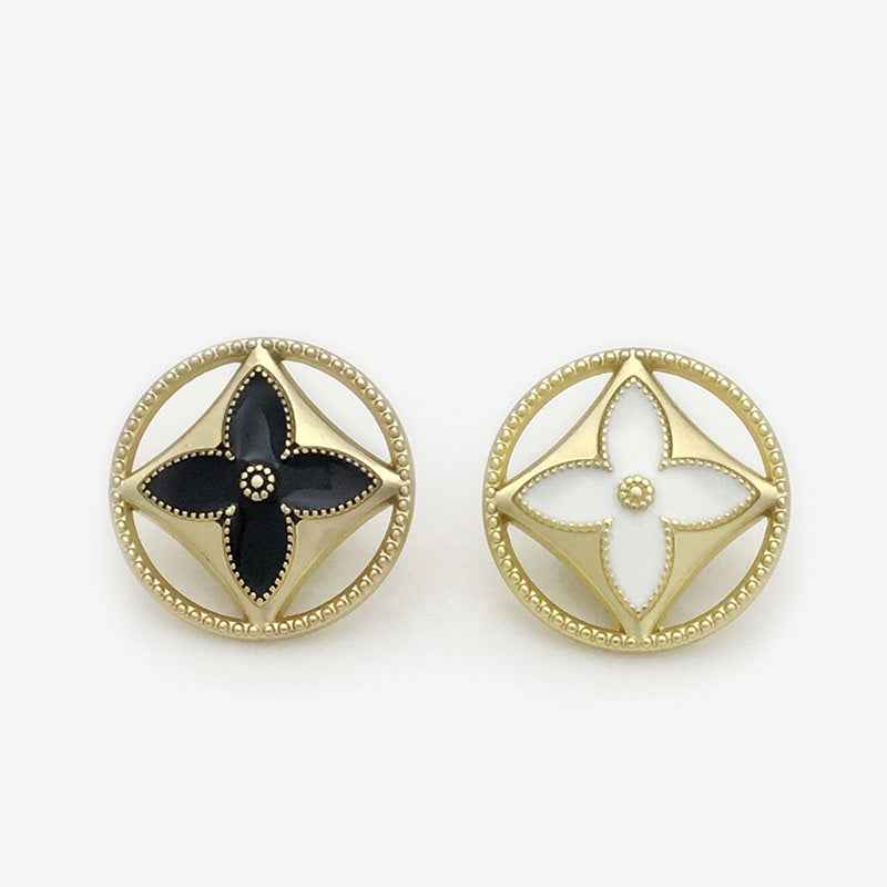Gold four-leaf clover shank buttons, one white and one black enamel front