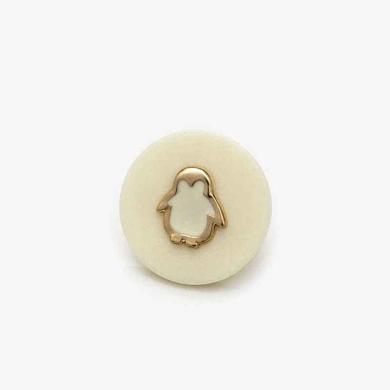 Beige resin shank button with gold penguin outline