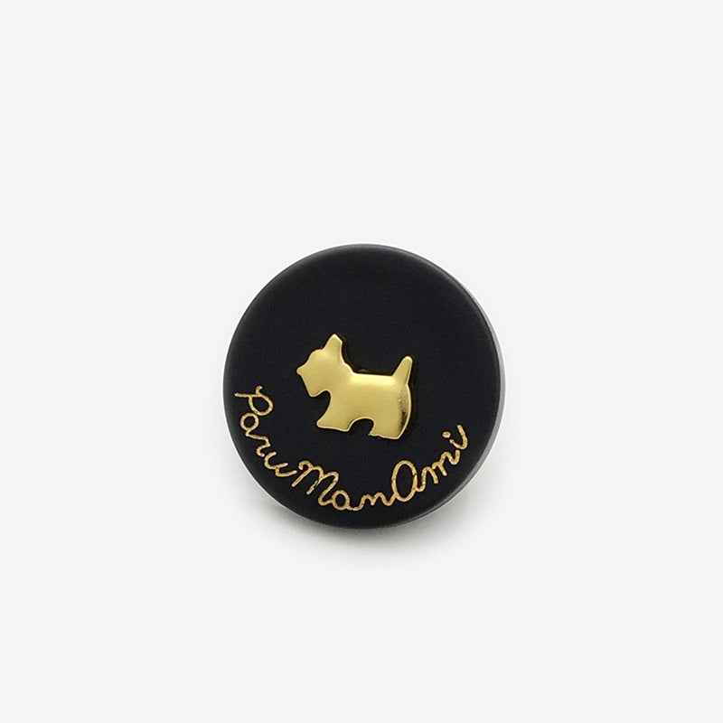 Beige dog-themed resin shank button with gold puppy silhouette and paw-name text