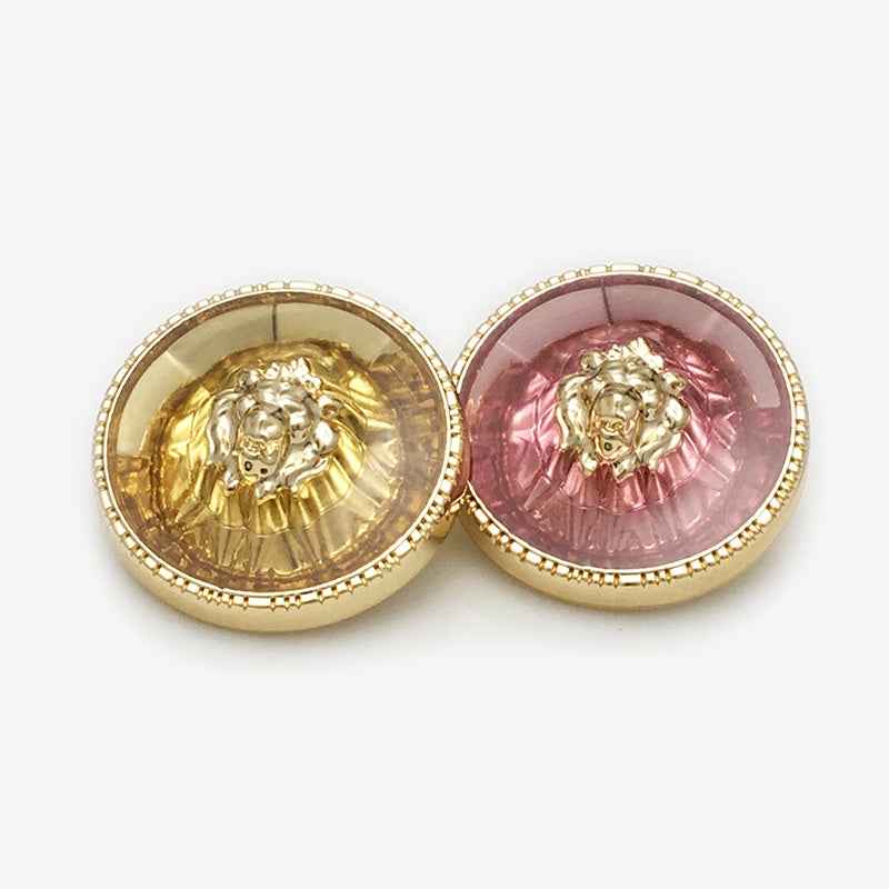 Pair of round lion-head shank buttons: gold-yellow and red transparent resin