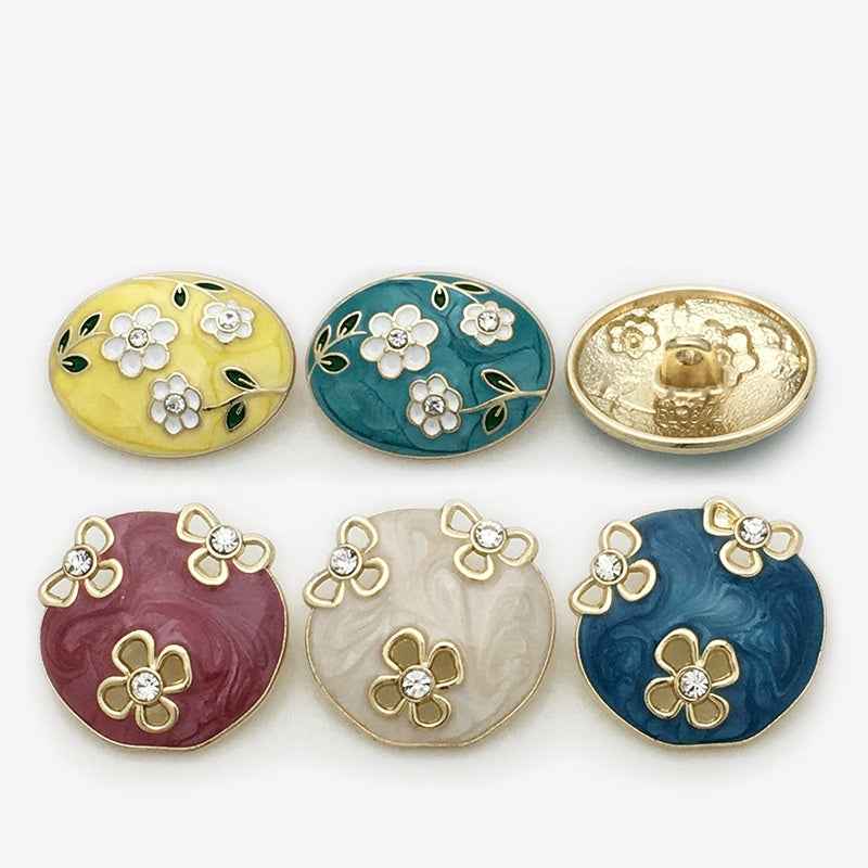 Assorted oval floral enamel metal buttons in yellow, teal, blue, red, and white