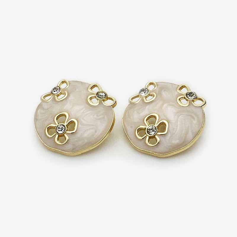Oval floral enamel metal button, white with gold edges and rhinestone flower details