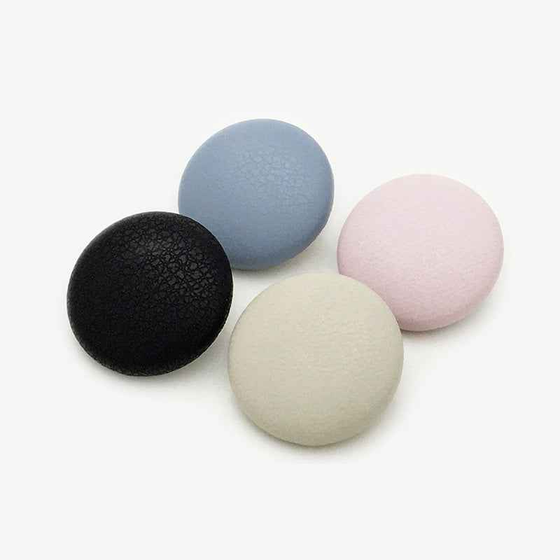 Assorted suede-effect metal shank buttons: black, blue, beige, pink, round faces.