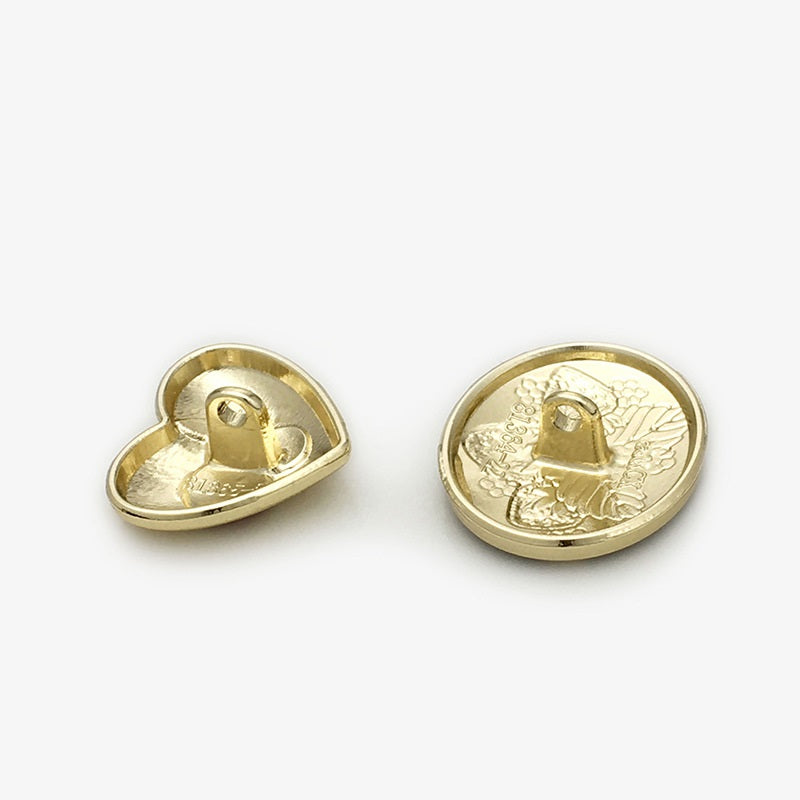 Heart-shaped metal button backs, gold color with central shank
