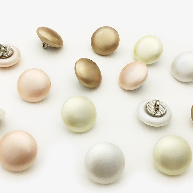 Pearl sew-on buttons showing metal backing and fronts, assorted colors
