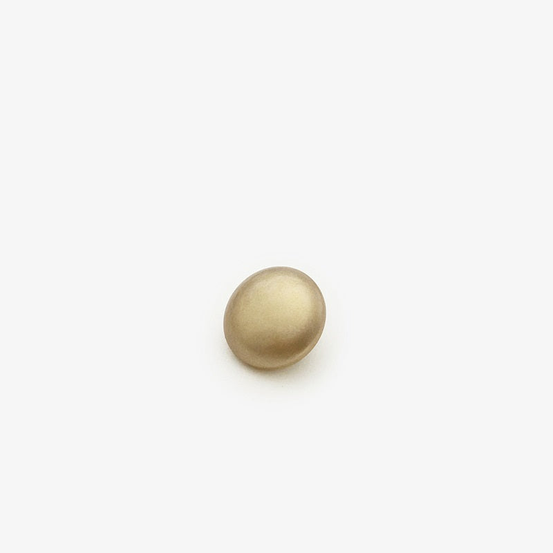 Coffee-colored pearl sew-on button with metal backing for coats, close-up